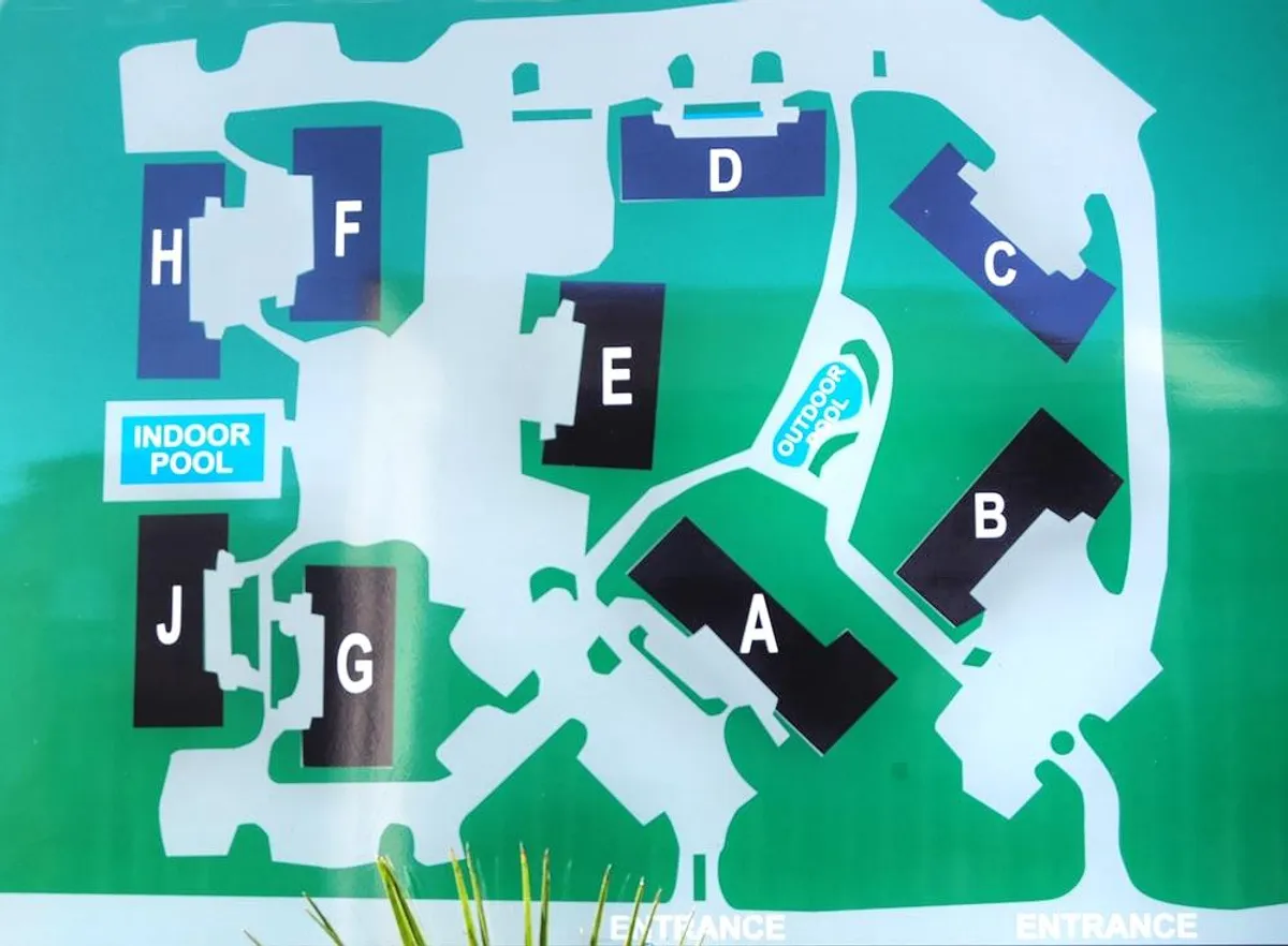 An inviting shot of the property’s indoor and outdoor pools, with clear signage and spacious lounging areas, showing off the resort-style amenities available for all ages. The layout encourages relaxation, group swimming, and social gatherings after a busy day out.